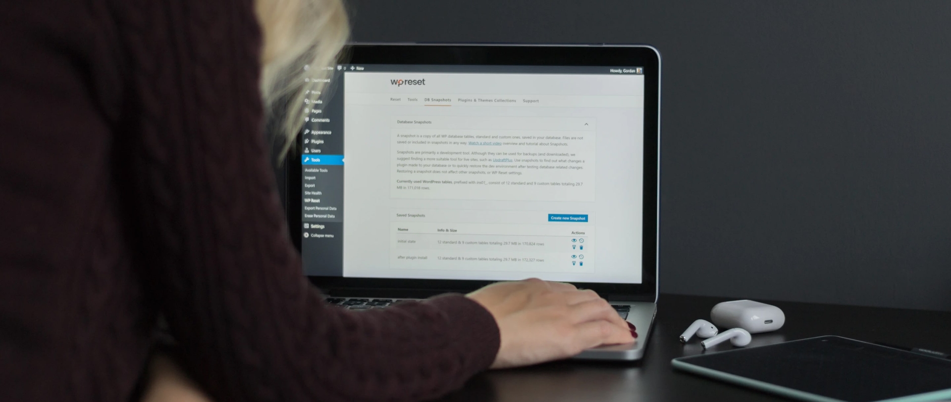 a woman working on laptop, screen shows Wordpress admin page